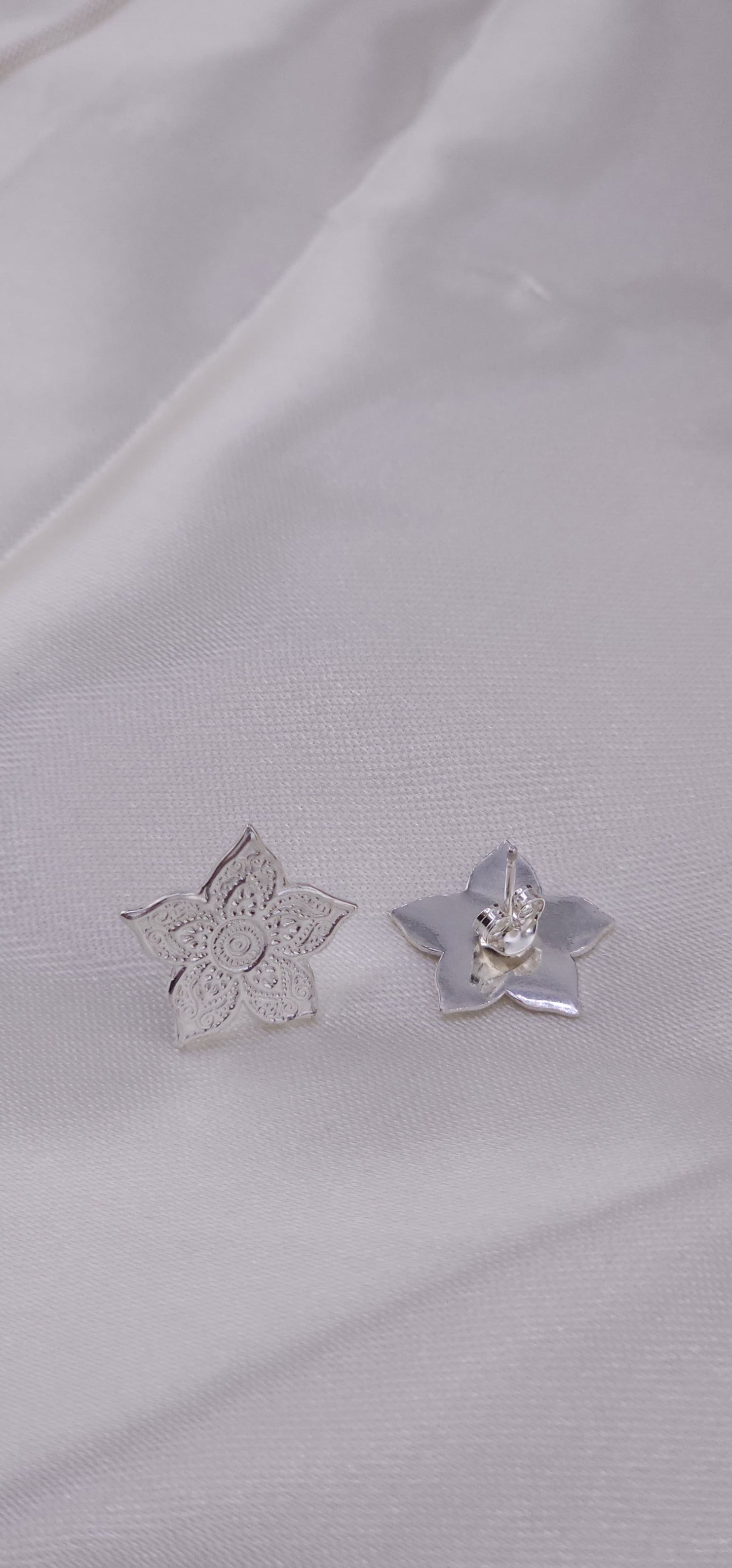 Sterling silver mandala stud earrings.