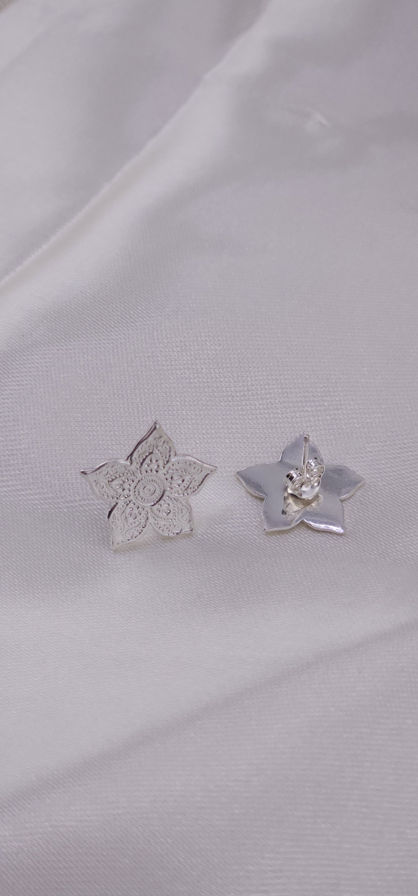 Sterling silver mandala stud earrings.